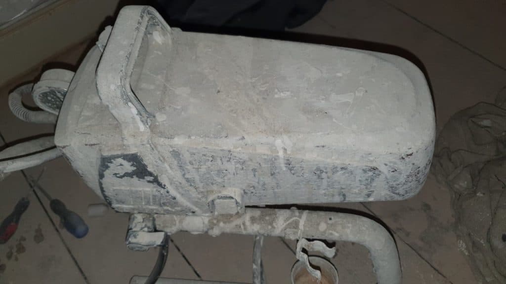 an airless sprayer covered in paint