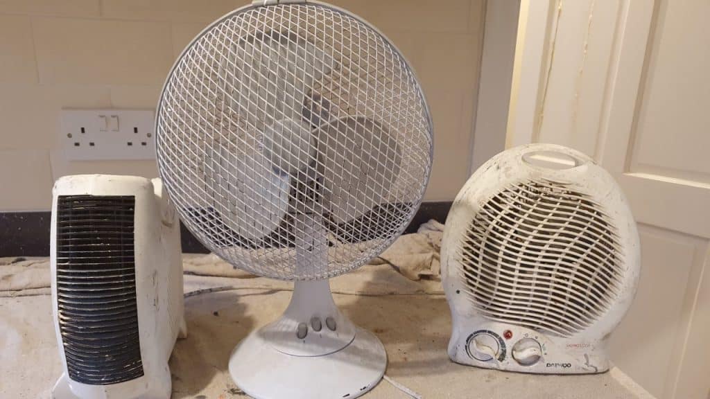 a fan and two fan heaters to speed up the drying process when painting
