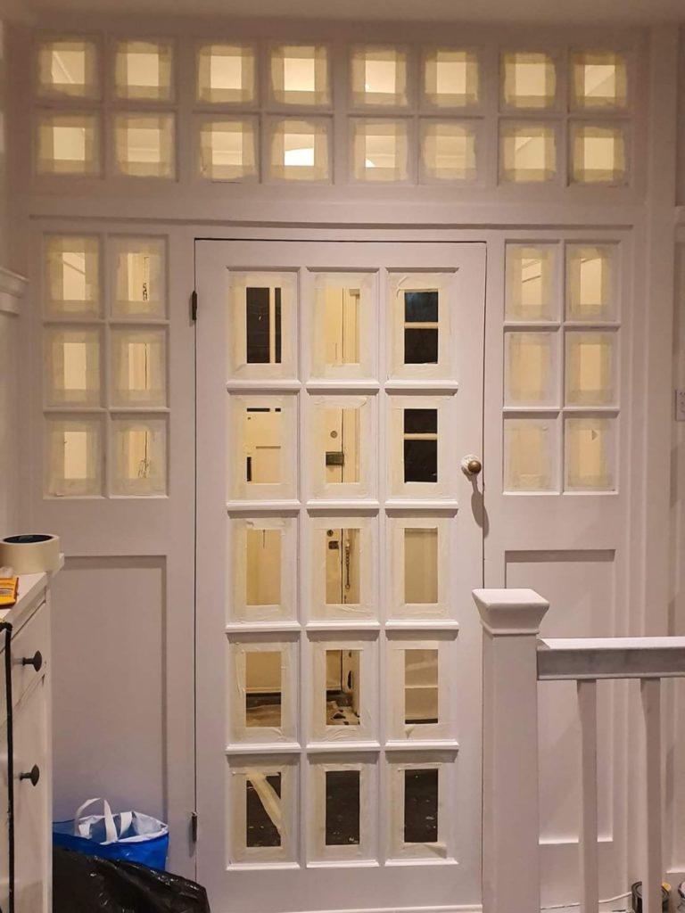 taped glass panel windows ready for painting