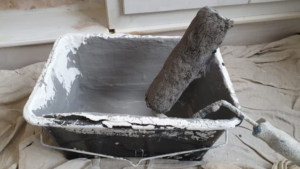 paint roller and scuttle with grey paint