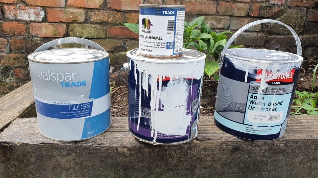 water-based gloss and undercoat tins with paint on them