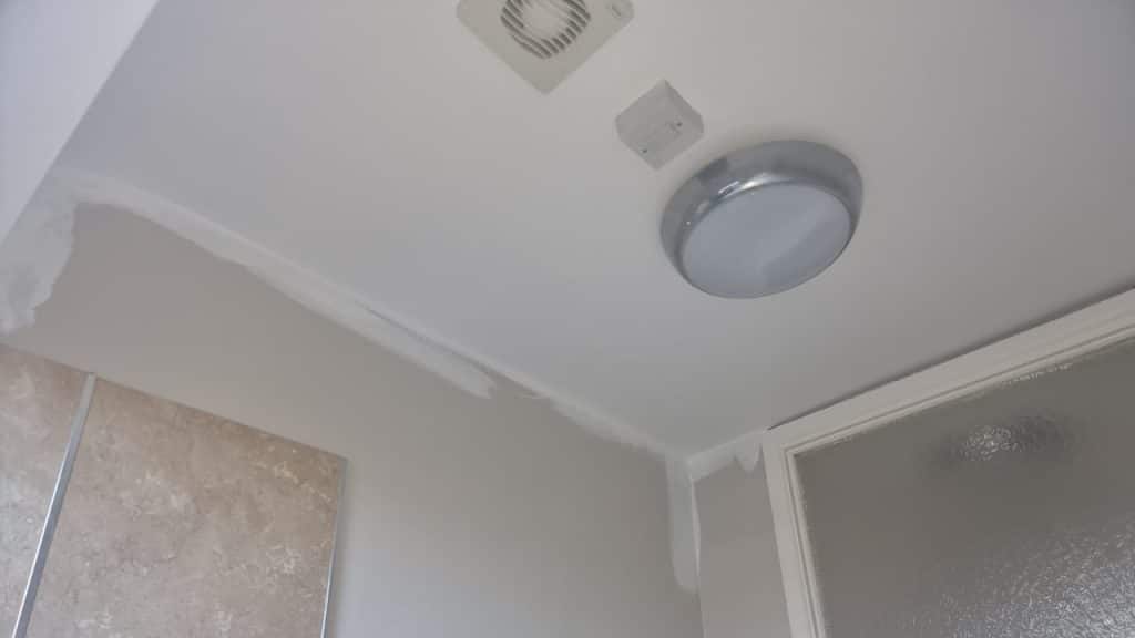 A bathroom ceiling that has just been painted with a durable emulsion to withstand steam