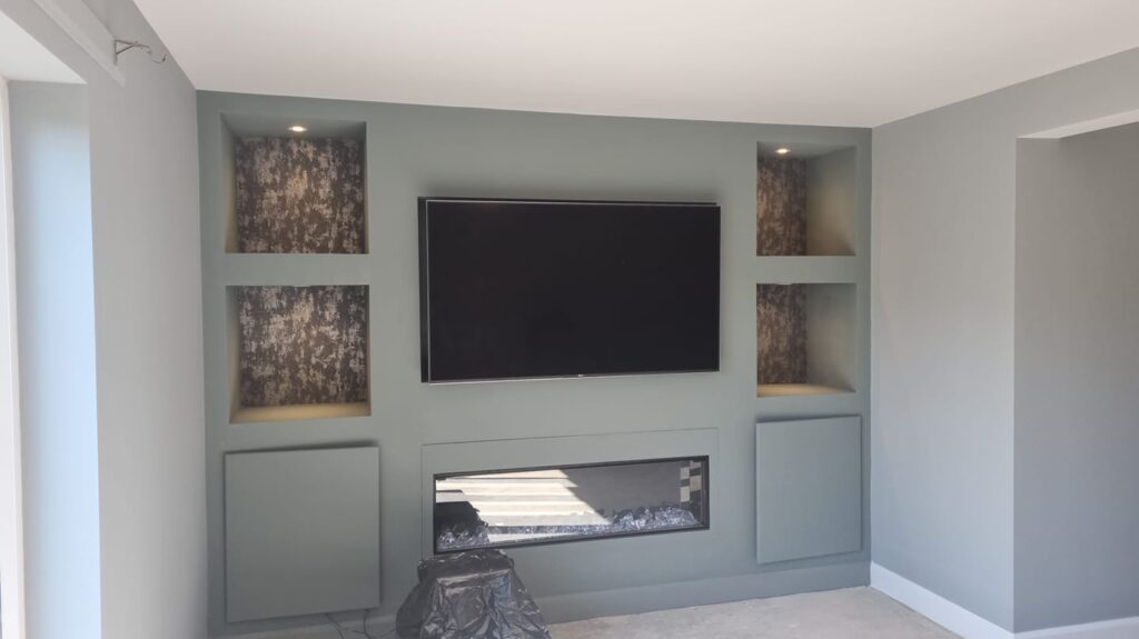 Wooden media wall painted with emulsion