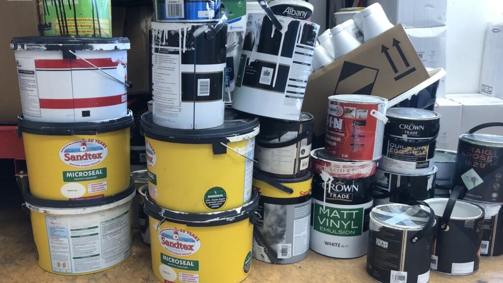 a collection of old paint tins