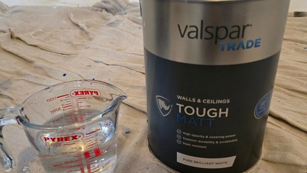 A tin of Valspar Trade Tough Matt and a jug of water