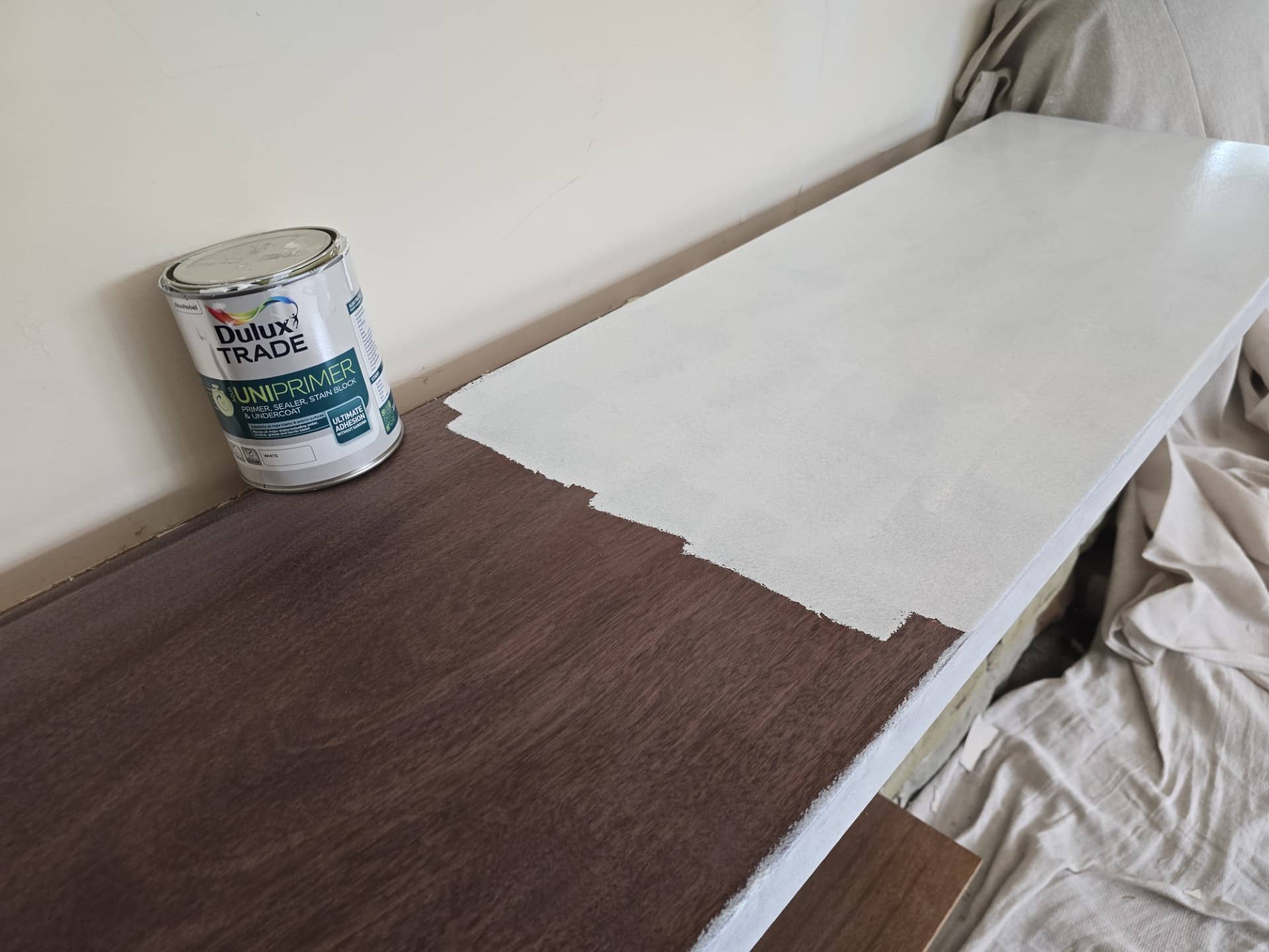 Applying Uniprimer to a brown wood stained surface