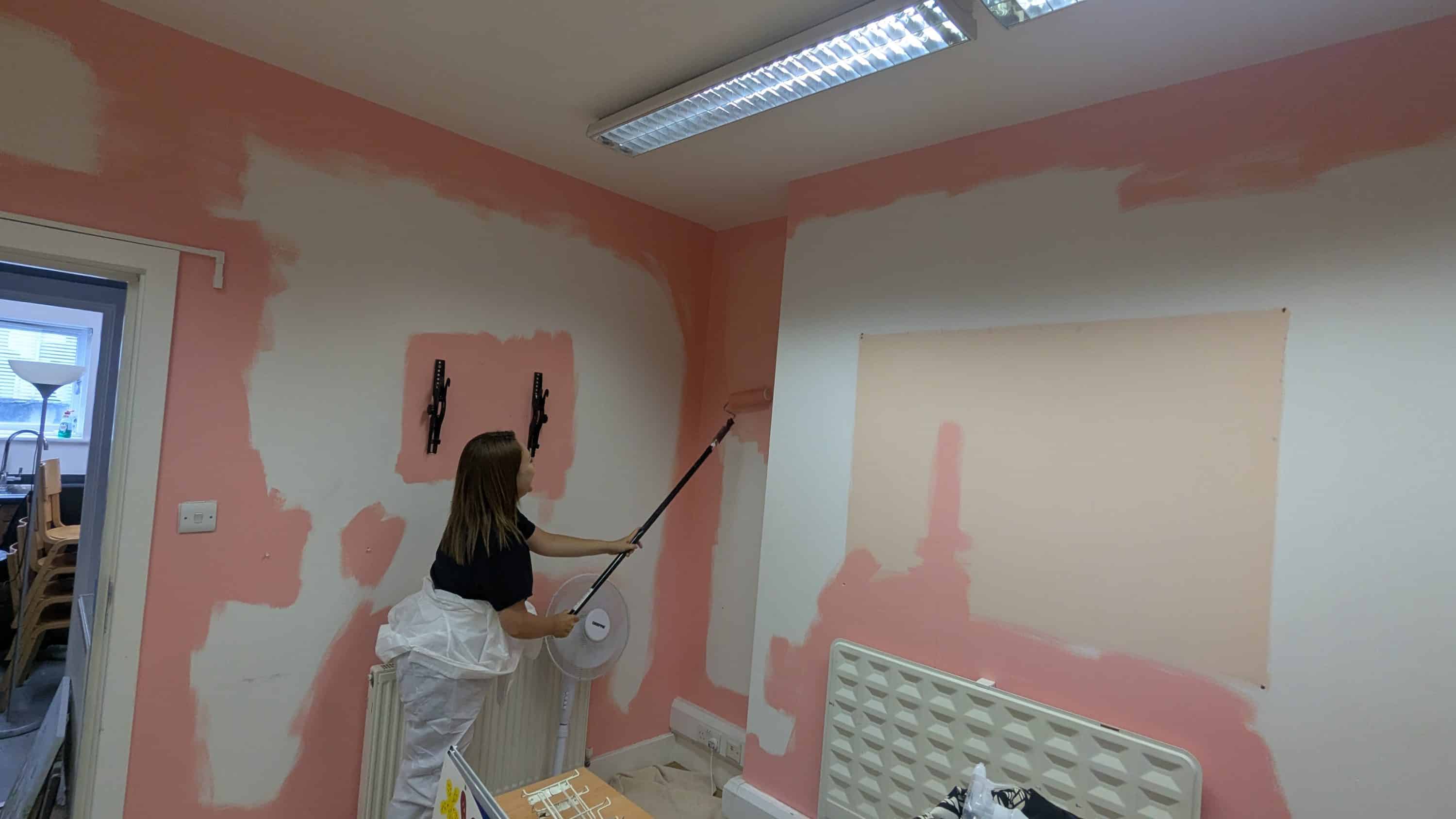 woman decorating walls for St Mungo's charity
