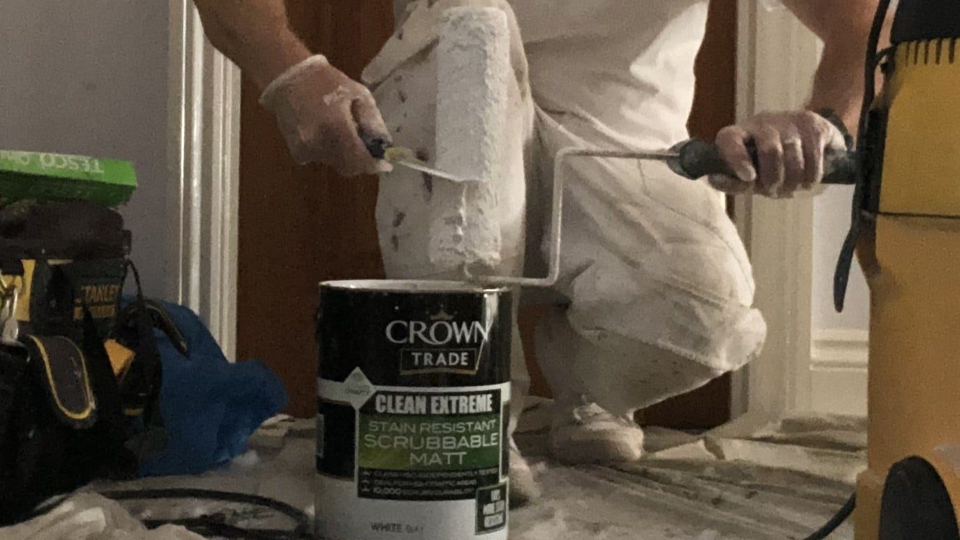 3 Scraping paint from a paint roller