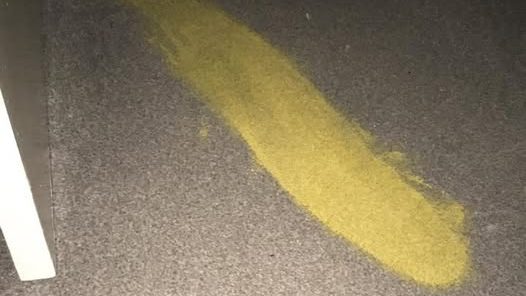 yellow paint spill on a carpet