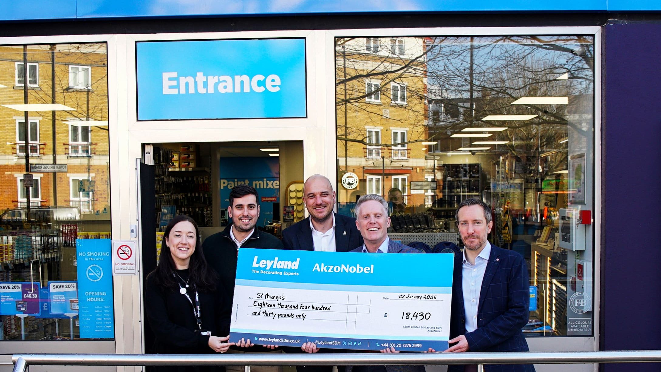 A donation from Leyland and Dulux being given to a man from St Mungo’s